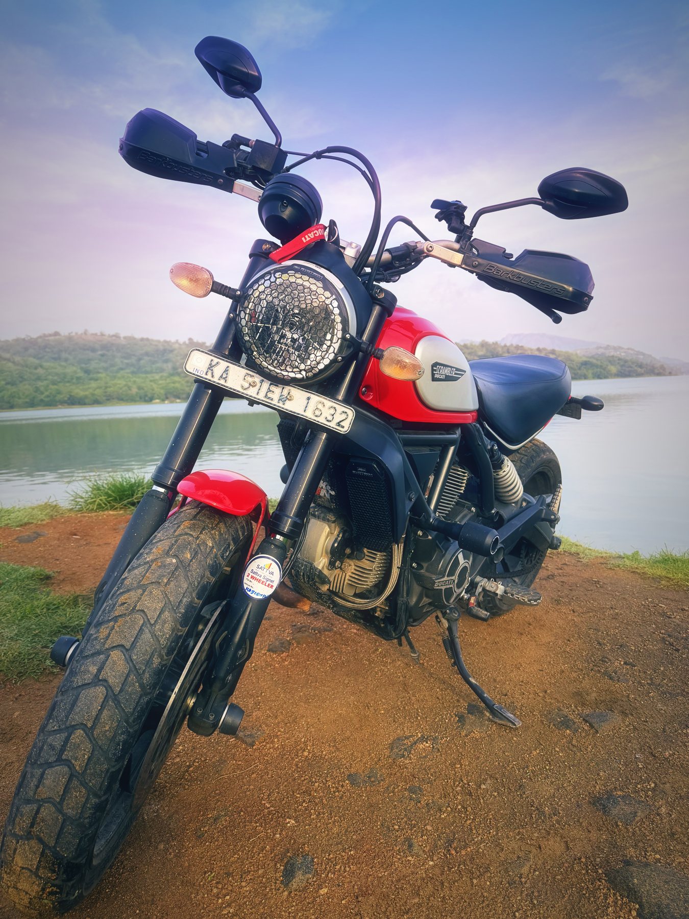 Low-angle shot of the Scrambler on the shore, reservoir and hills behind